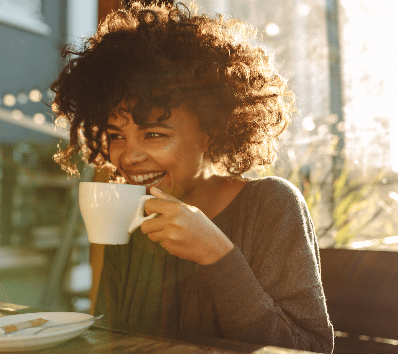 Emerge Therapy patient in a warm, golden-hour lit telehealth session